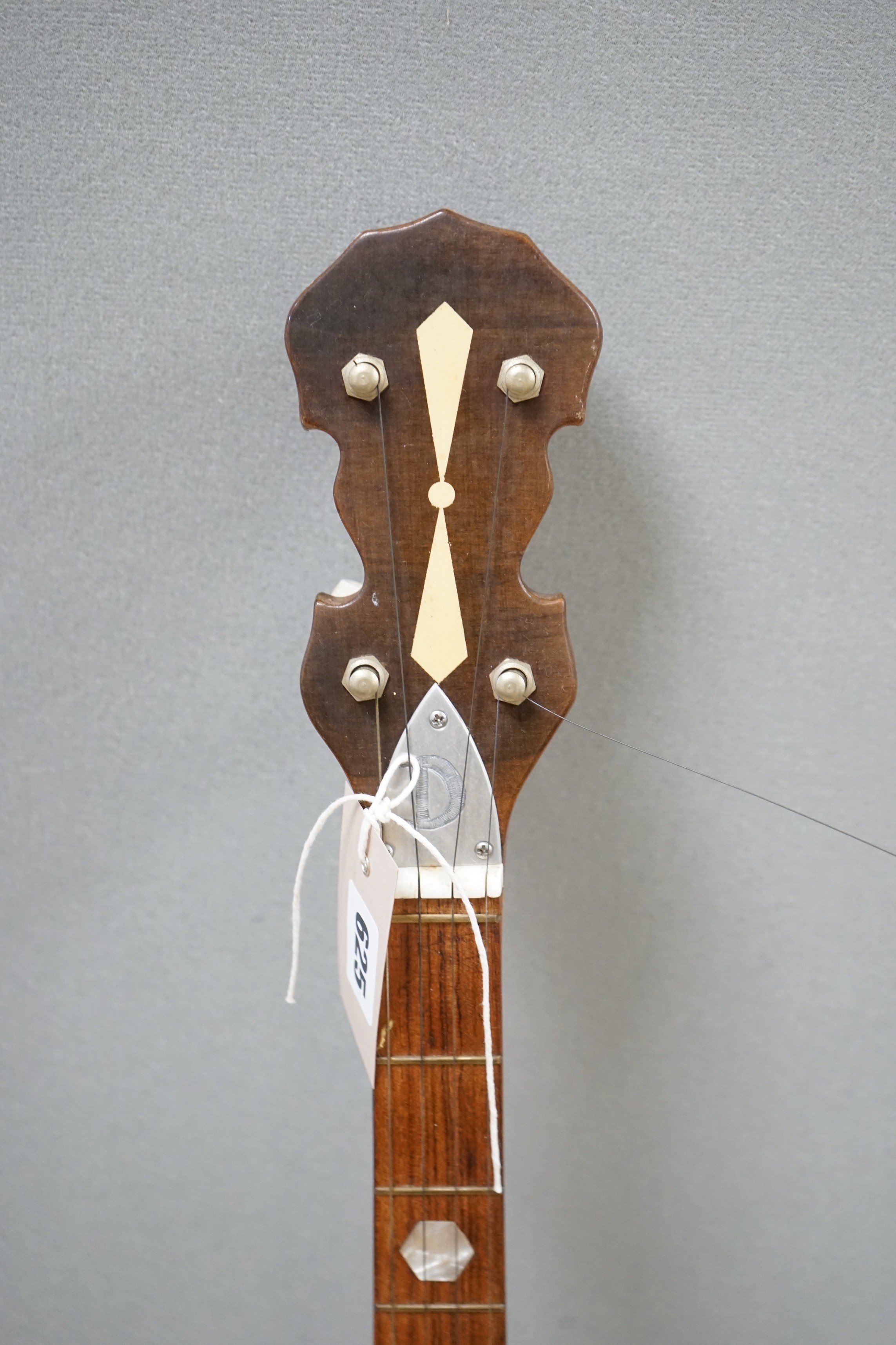 A five string banjo made by John Degay of Degay Guitars